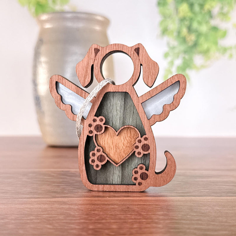 The Forged Flare® Forever In My Heart Dog Angel Ornament, featuring angel wings, a heart on its chest, and paw prints, is perfect as a personalized dog lover gift and looks beautiful displayed on any surface.