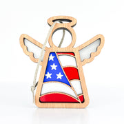 The Forged Flare® Mother's Angels® 3.5" Angel Figurine ornament features a cutout center with an American flag design in red, white, and blue stars. Includes a hanging string. A patriotic gift—American Flag Ornament shown on a plain white background.