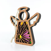 The Forged Flare® Aster Ornament | 3.5" (H) Angel Figurine from Mother's Angels® features a cutout purple aster flower, colorful stained glass, white wings, and a twine loop for hanging; shown on a white background.