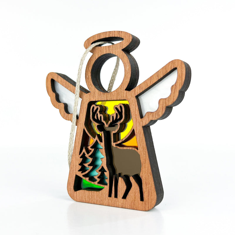 The Forged Flare® Autumn Deer Ornament is a 3.5" Mother's Angels® wooden angel figurine with stained glass accents and cut-out deer and pine trees—perfect as a fall décor piece or unique gift for deer hunters.