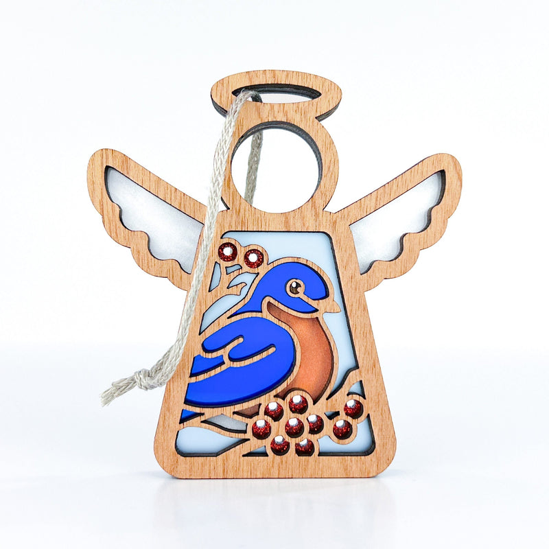 The Bluebird Ornament | 3.5" (H) Angel Figurine by Forged Flare® features open wings, a blue and brown bird, red berries, intricate cut-outs, and a light hanging string—perfect as a Mother's Angels® Memorial Gift.