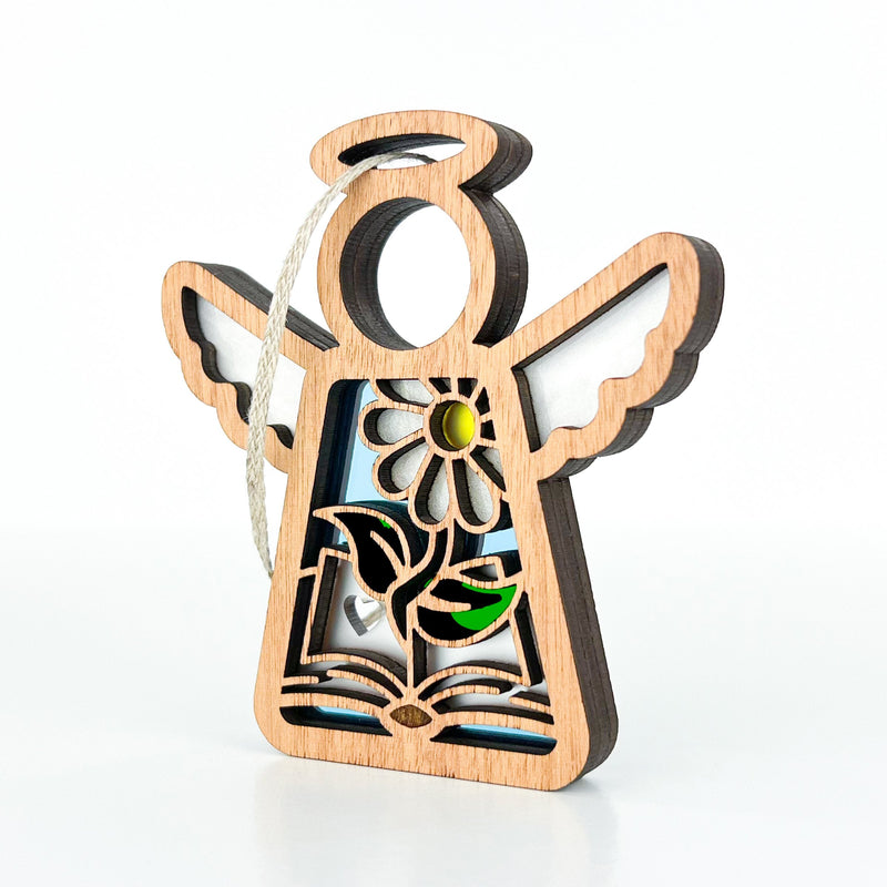 The Forged Flare® Book Lovers Ornament is a 3.5" Mother's Angels® figurine with cut-out flower and heart details, colored accents, and a hanging string. Perfect as an author or book club gift, it’s shown on a white background.