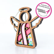 The Forged Flare® Mother's Angels® 3.5" Breast Cancer Awareness Ribbon for Charity Ornament is a wooden angel with pink ribbon, colorful accents, and a note that proceeds benefit Susan G. Komen—perfect for Breast Cancer Awareness Month.