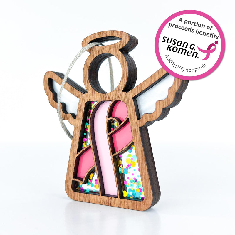 The Forged Flare® Mother's Angels® 3.5" Breast Cancer Awareness Ribbon for Charity Ornament is a wooden angel with pink ribbon, colorful accents, and a note that proceeds benefit Susan G. Komen—perfect for Breast Cancer Awareness Month.