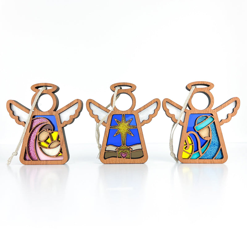 The Forged Flare® Christmas Nativity 3-Piece Bundle includes 3.5" Mother's Angels® figurines: a star, Mary and Joseph, each with colorful stained glass-style painted designs.