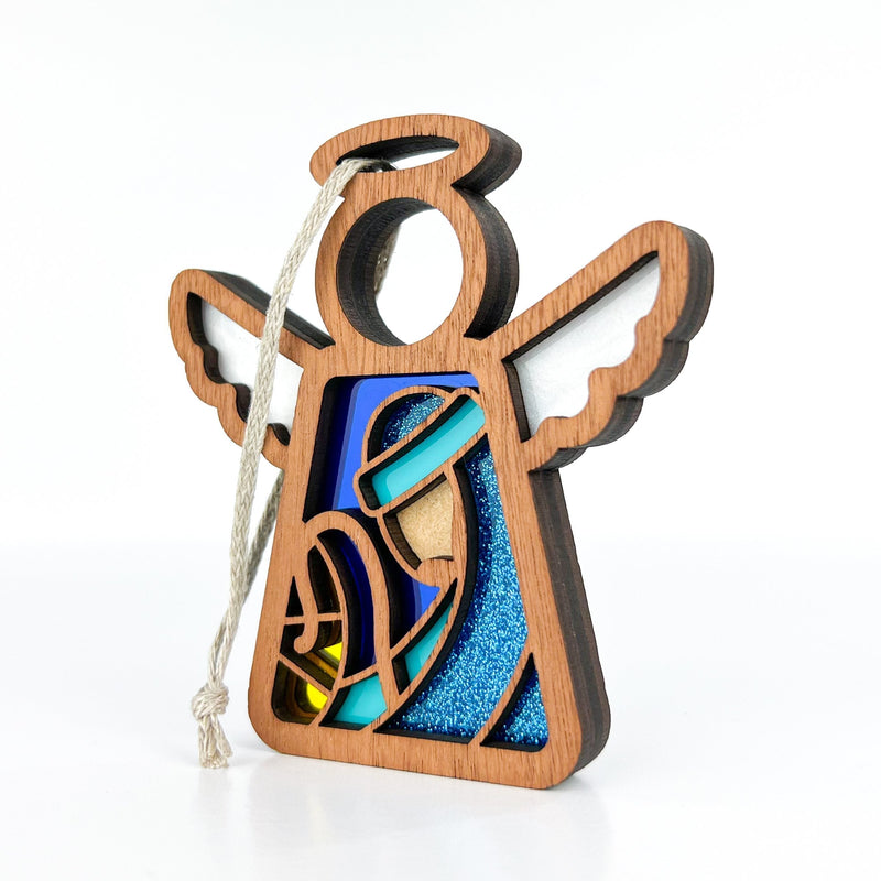 The Forged Flare® Christmas Nativity Joseph 3.5" (H) Angel Figurine by Mother's Angels® features layered wood designs with blue and yellow accents, white wings, and a rope loop for hanging—perfect as a Nativity gift.