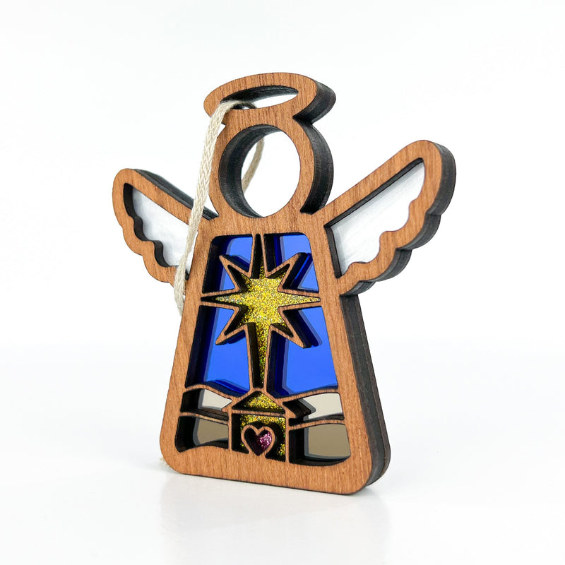 The Christmas Nativity Star with Imperfections 3.5" Angel Figurine by Forged Flare® Mother's Angels® features white wings, a blue stained-glass robe, and a manger star, making it a meaningful gift and festive addition to your holiday décor.