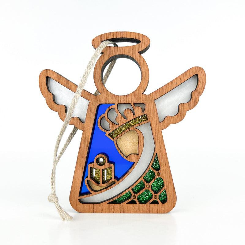 The Christmas Nativity Green Wise Man 3.5" Angel Figurine by Forged Flare® features a blue background, gold bell, candle, green glittered trees, and white wing and halo accents. Includes string loop for hanging. Part of Mother's Angels®.