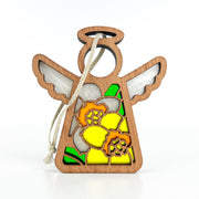 The Forged Flare® Mother's Angels® Daffodil Ornament is a 3.5" wooden angel with stained glass-style wings and orange daffodil designs. It features a string loop for hanging and makes a perfect birth flower gift.