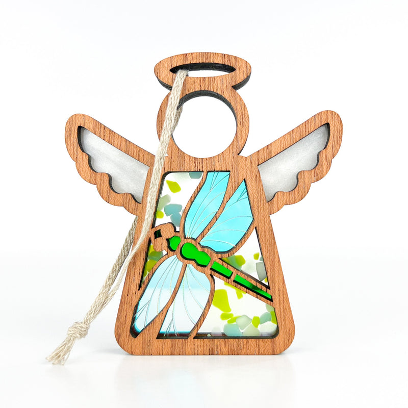 A 3.5" Mother's Angels® dragonfly angel ornament by Forged Flare® features light blue stained glass wings, a green body, and a light string for hanging. Ideal for Amazon; warehouse return. White background.
