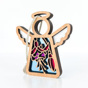 The Fuchsia Ornament, a 3.5" (H) wooden angel figurine by Forged Flare® Mother's Angels®, features pink and blue cutout floral and abstract designs with a string loop—perfect as a charming Christmas tree ornament or thoughtful flower gift.