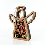 The Forged Flare® Gladiolus Ornament is a 3.5" Mother's Angels® wooden angel figurine with white wings, halo, and a red, green & yellow gladiolus cut-out design, plus a white string loop for hanging. Shown on a white background.