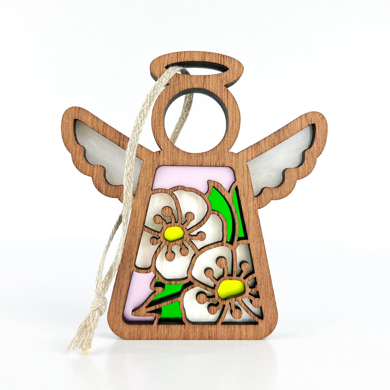 The Forged Flare® Hawthorn Ornament is a 3.5" Mother's Angels® wooden angel figurine with outstretched wings, hanging string, and floral stained-glass design featuring May’s birth flower—hawthorn—with two white blooms and green leaves.