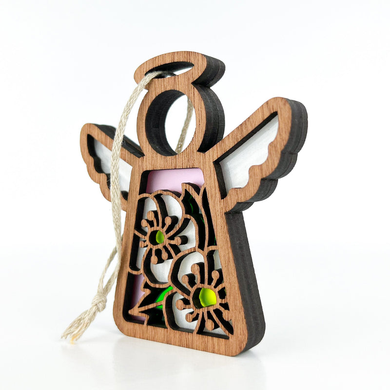 The Forged Flare® Hawthorn Ornament is a 3.5" Mother's Angels® figurine featuring intricate hawthorn flower cutouts, white wings, and a cream-colored hanging string, shown upright on a white background.