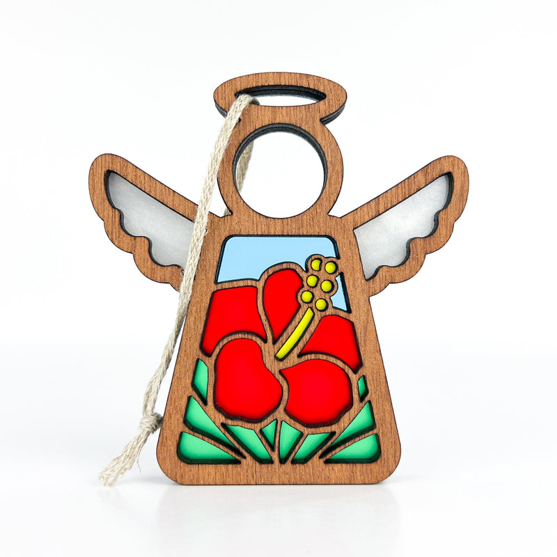 The Forged Flare® Hibiscus Ornament is a 3.5" Mother's Angels® wooden angel figurine with white wings, a halo, a cutout face, and a red hibiscus flower design—perfect as a Hawaiian-inspired Christmas ornament with hanging string.