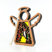 A 3.5" wooden angel figurine from Forged Flare® Mother's Angels®, featuring a stained-glass style ruby-throated hummingbird design, white wings, halo, and hanging loop. This is a warehouse return ornament.