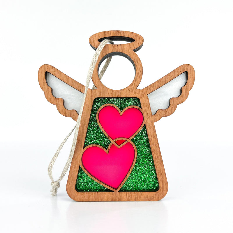 The Forged Flare® Limited Edition Interlocking Hearts Ornament - Series 8 is a 3.5" Mother's Angels® figurine featuring pink hearts, green glitter, white wings, and string for hanging—perfect for your Christmas tree. Displayed on a white background.