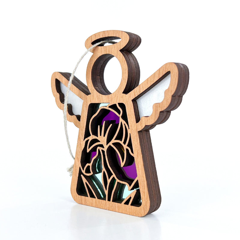 The Forged Flare® Iris Ornament is a 3.5" Mother's Angels® figurine with wings, halo, and stained glass-style purple, black, and green inlay—perfect for any angel collection. Includes white hanging string.