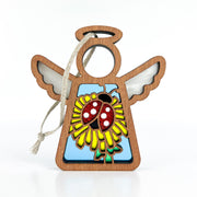 The Forged Flare® Mother's Angels® Ladybug and Dandelion Ornament is a 3.5" wooden angel figurine with a stained glass-style ladybug and flower design—perfect as a unique tree ornament.