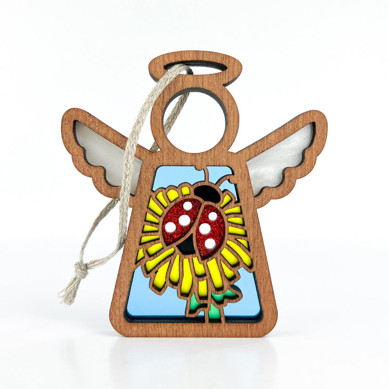 The Forged Flare® Mother's Angels® Ladybug and Dandelion Ornament is a 3.5" wooden angel figurine with a stained glass-style ladybug and flower design—perfect as a unique tree ornament.