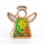 The Forged Flare® Marigold Ornament is a 3.5" wooden angel figurine from Mother's Angels®, featuring a cut-out floral design with bright marigolds on green and a white hanging string.