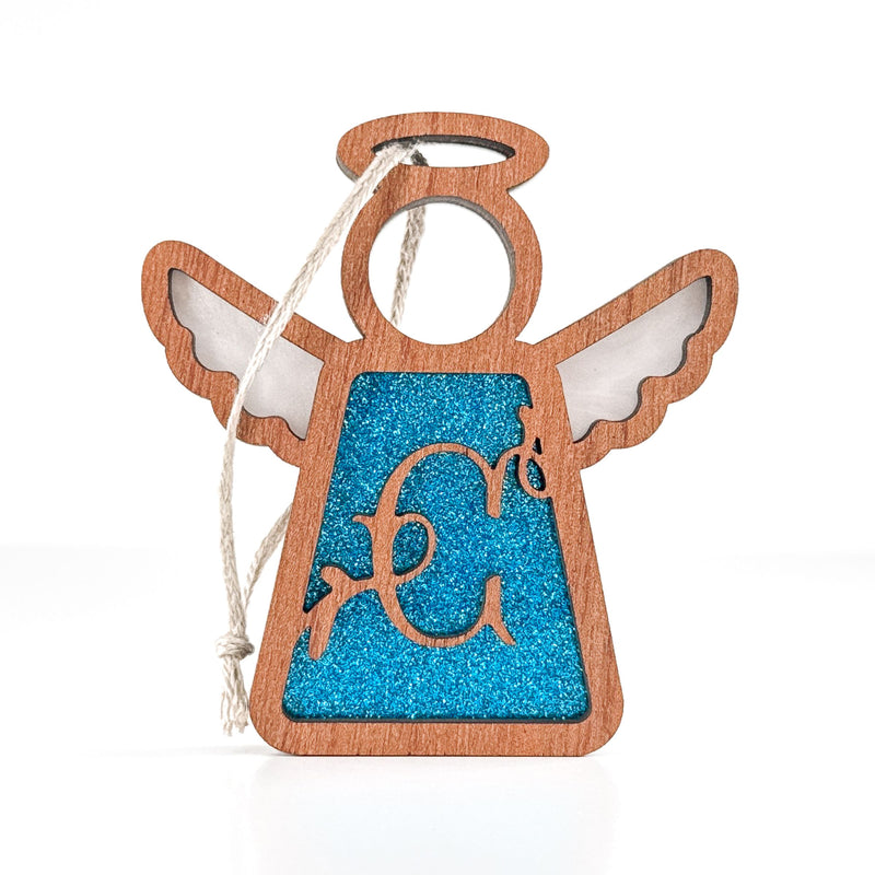 The Forged Flare® Personalized C Monogram Ornament is a 3.5" wooden angel figurine with a blue glitter center, white hanging string, and decorative "C" on the front—an ideal personalized gift for mom from Mother's Angels®.
