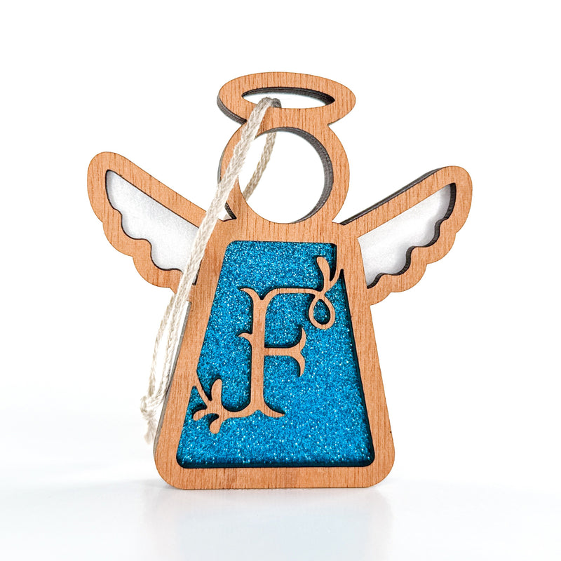 The Forged Flare® Mother's Angels® Personalized F Monogram Ornament is a 3.5" wooden angel figurine with a blue glittery center, "F" cutout, and hanging string—perfect for a custom Christmas touch.