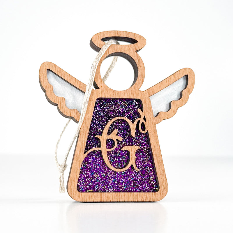 Front view of a purple sparkle letter G angel ornament - a custom monogram gift for mom’s holiday decor