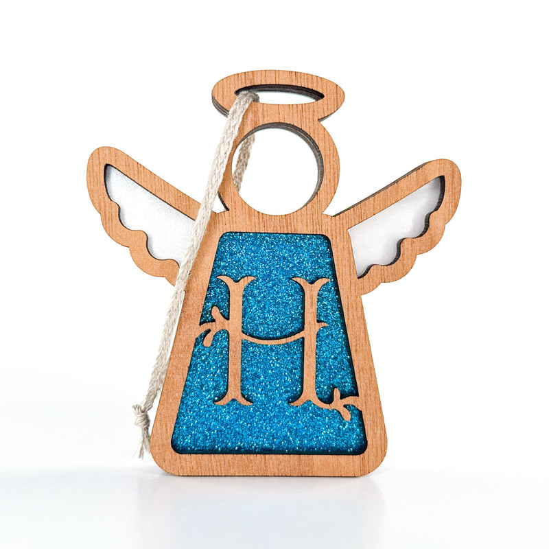 The Forged Flare® Mother's Angels® Personalized H Monogram Ornament is a 3.5" wooden angel figurine with a blue glitter "H", wings, halo, and a twine loop—perfect for personalizing your Christmas decor.