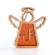 The Forged Flare® Personalized J Monogram Ornament is a 3.5" Mother's Angels® wooden angel figurine with white wings, an orange glittery body, and a cut-out "J," finished with a twine loop for hanging.