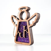 Side view of a purple glitter J initial ornament, displaying its layered artistry for holiday or everyday use