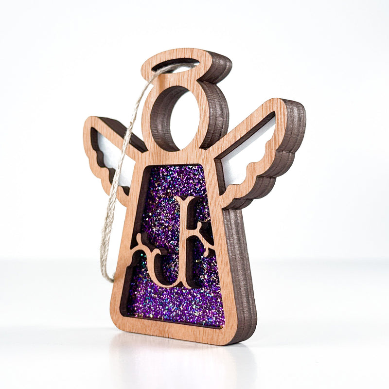 Side view of a purple glitter J initial ornament, displaying its layered artistry for holiday or everyday use