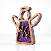 Side view of a purple sparkle K monogram ornament, highlighting its Texas-crafted depth for special gifts