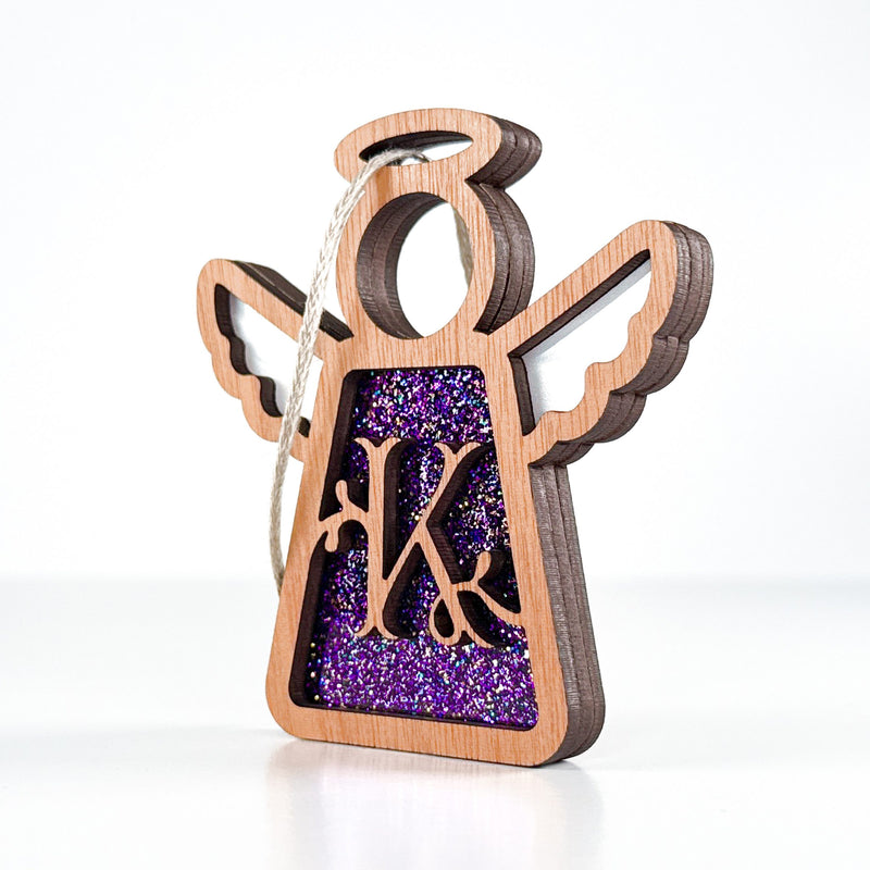 Side view of a purple sparkle K monogram ornament, highlighting its Texas-crafted depth for special gifts