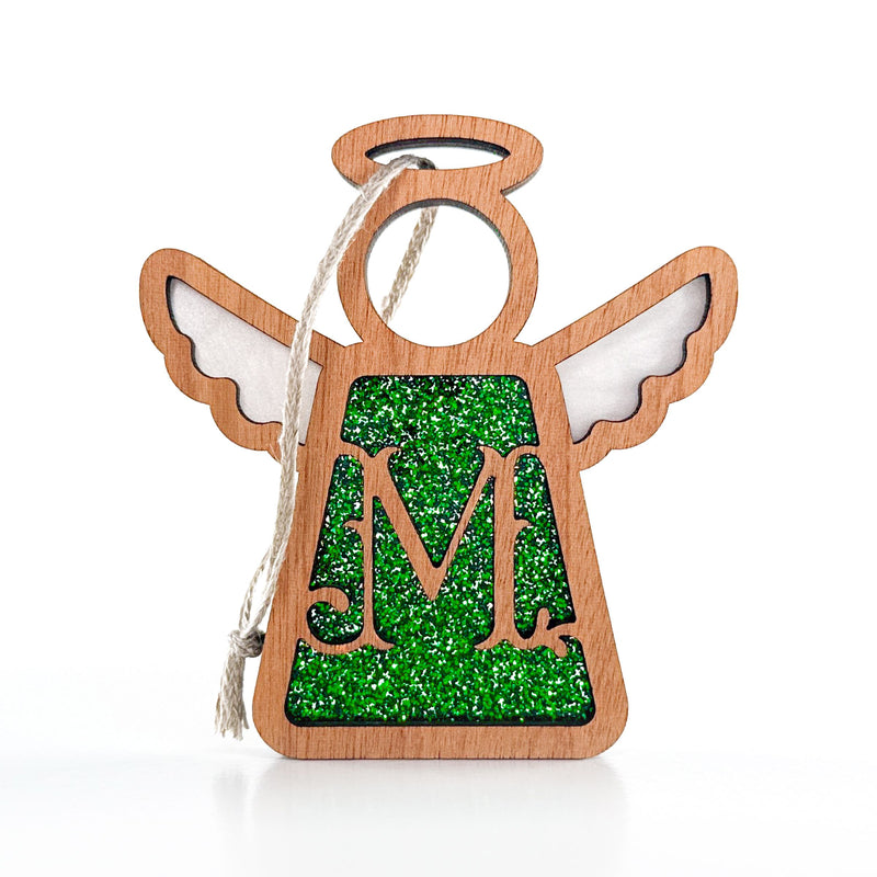 The Forged Flare® Mother's Angels® 3.5" Personalized M Monogram Ornament features a wooden angel with wings, halo, green glitter center, and hanging string—perfect as a custom Christmas decoration.