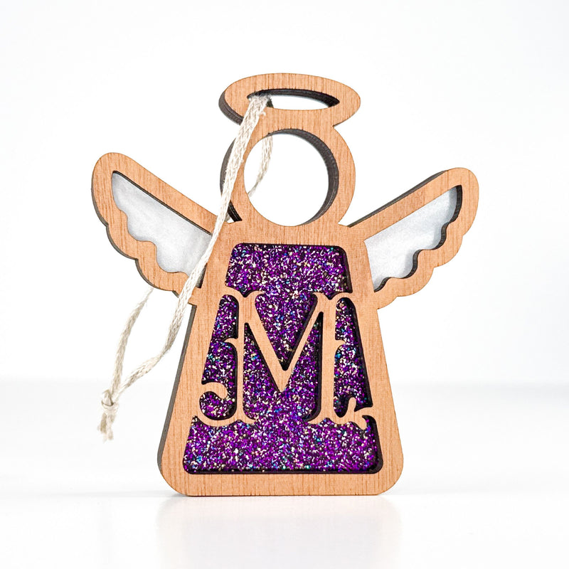 Front view of a purple sparkle letter M angel ornament - a thoughtful monogram gift for her celebrations