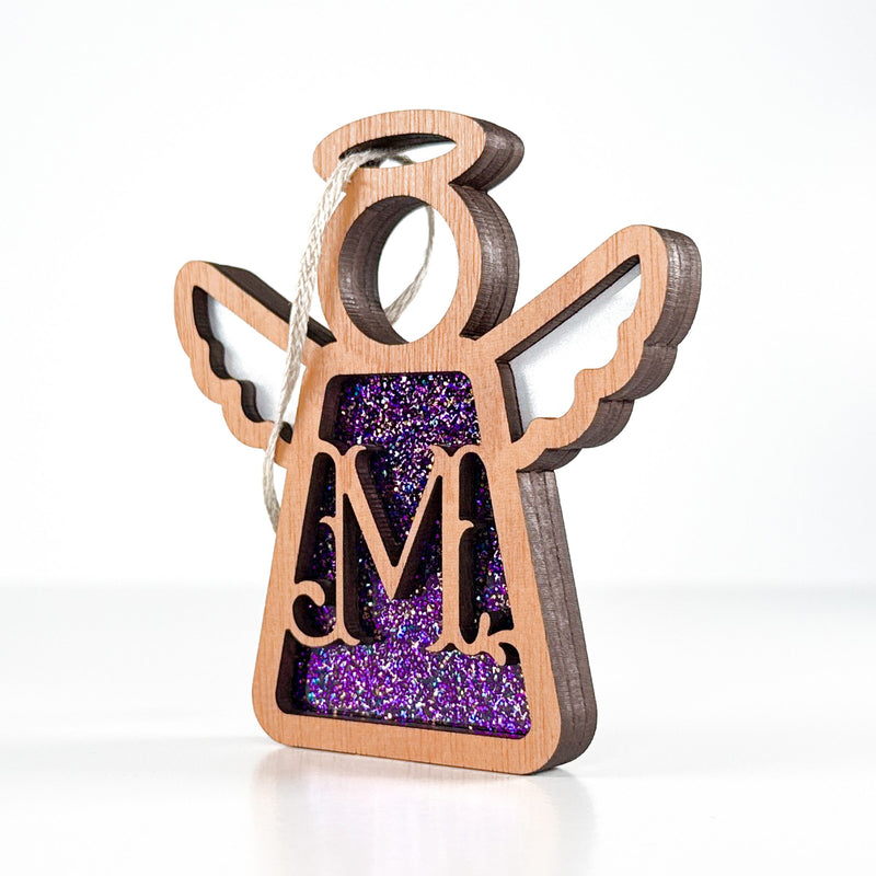 Side view of a purple glitter M monogram ornament, revealing its handcrafted Texas elegance for year-round display