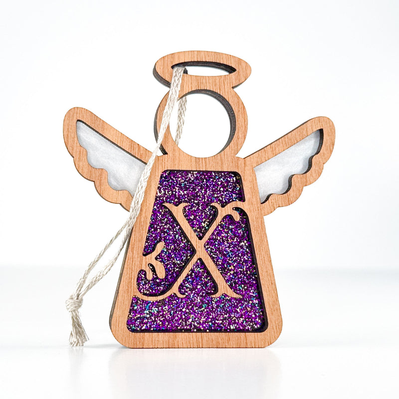 Front view of a glittery purple letter X monogram angel - an ideal personalized ornament for mom’s tree