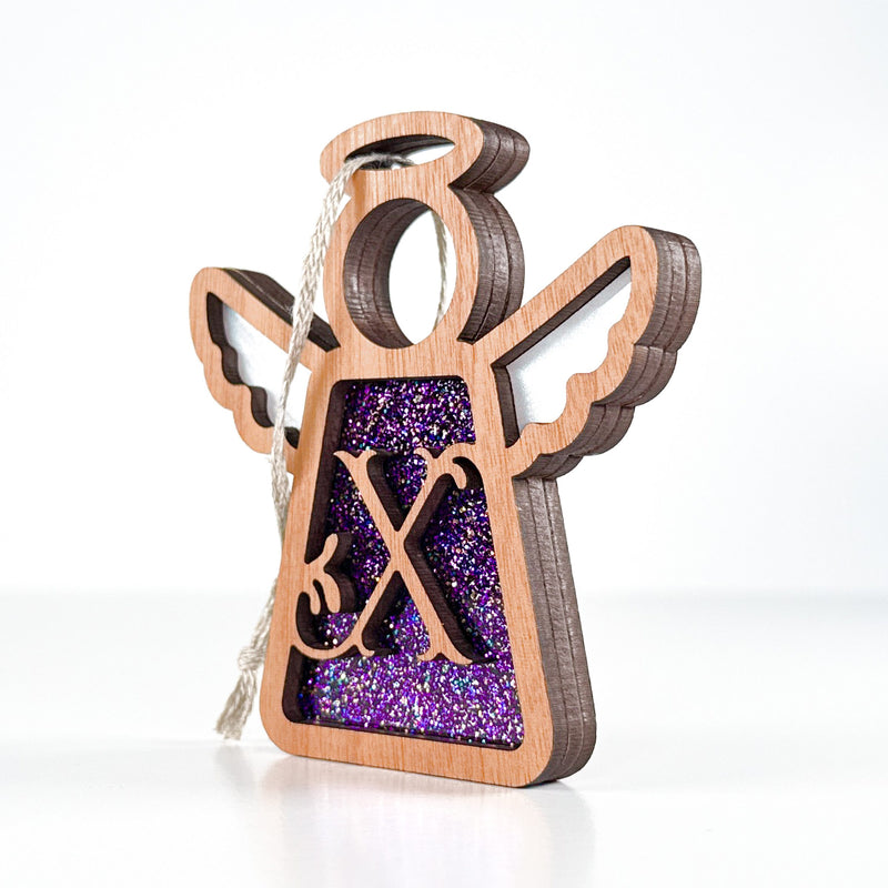 Side view of a purple sparkle X initial ornament, revealing its handmade layers for Christmas keepsakes