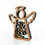 The Morning Glory Ornament by Forged Flare® is a 3.5" (H) Mother's Angels® figurine featuring white wings, a circular head, and string for hanging. Its stained glass-style body displays September’s blue morning glory flower on a white background.