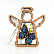 The Forged Flare® Mother's Angels® Warehouse Return - Morpho Blue Butterfly Ornament is a 3.5" wooden angel figurine with open wings, blue glitter butterfly, jute hanger, and a stained glass-style interior for unique charm.