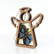 The Forged Flare® Mother's Angels® Morpho Blue Butterfly Ornament is a 3.5" wooden angel with white wings, a blue glitter butterfly at its center, and a hanging loop—shown on a plain white background.