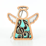 The Forged Flare® Mother's Angels® Music Ornament is a 3.5" wooden angel figurine with teal and black music notes, white wings, and a halo—ideal for music lovers or as a thoughtful gift for a music teacher.
