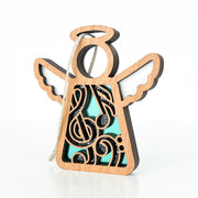 The Forged Flare® Mother's Angels® Music Ornament is a 3.5" wooden angel figurine with musical note cut-outs, blue background, black and white accents, and a hanging string—ideal as a music teacher gift.