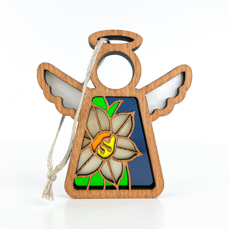 The Forged Flare® Narcissus Ornament is a 3.5" Mother's Angels® angel figurine with halo and wings, showcasing a stained glass-style December narcissus flower on green and blue, and includes a hanging string.