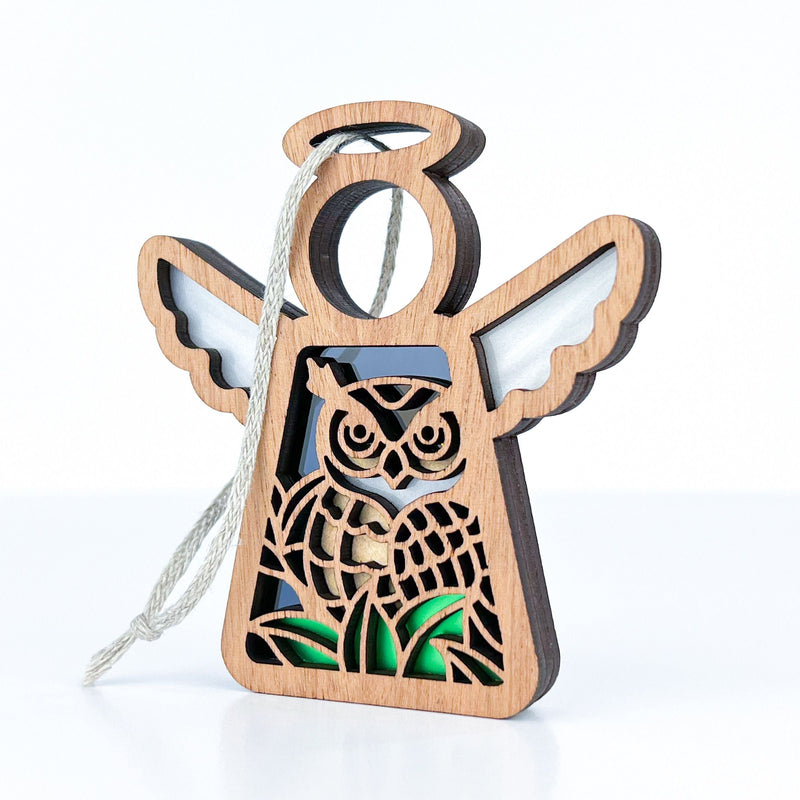 The Forged Flare® Owl Ornament | 3.5" (H) Angel Figurine from Mother's Angels® features an angel-shaped wooden design with wings, halo, cutout owl detail, and hanging string—a perfect bird lover or bird watching gift.