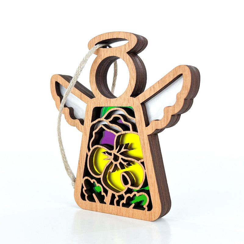 The Forged Flare® Pansy Ornament is a 3.5" Mother's Angels® wooden angel with yellow and purple stained-glass effect and cut-out details, perfect for hanging on your Christmas tree or adding to your angel figurines collection.