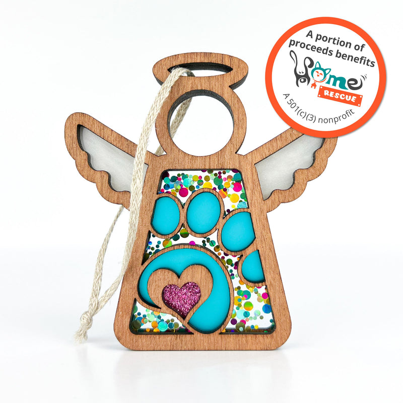 The Forged Flare® Paw Print for Charity Ornament (3.5" angel) features blue paw prints, a pink glitter heart, and colorful dots. Proceeds benefit Home Rescue 501(c)(3). A thoughtful pet loss or memorial gift from Mother's Angels®.
