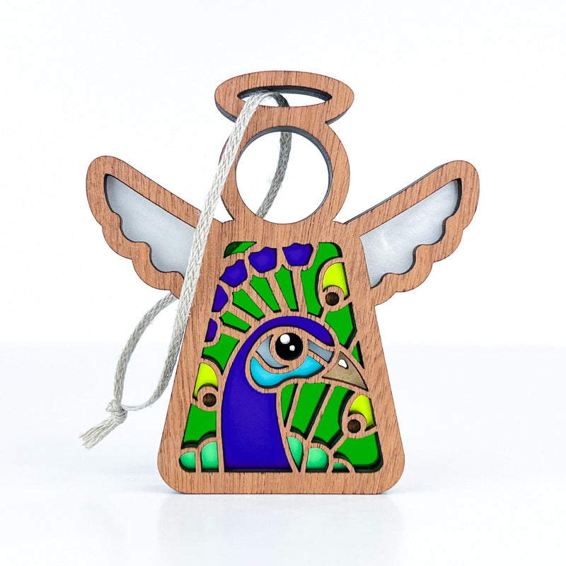 The Peacock Ornament | 3.5"(H) Angel Figurine from Forged Flare® features a colorful stained glass-style peacock design and a hanging string—ideal as a gift for bird lovers or a unique holiday décor piece. Part of the Mother's Angels® collection.