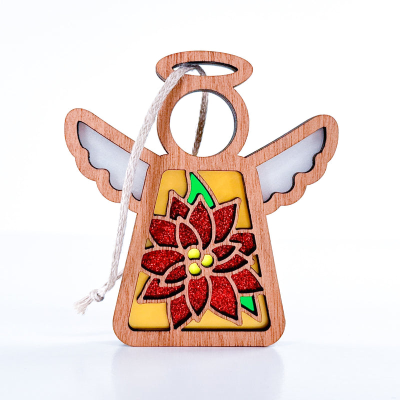 The PREORDERS CLOSED! Poinsettia Ornament by Forged Flare® is a 3.5" handmade Mother's Angels® figurine with white wings, a round halo, red glitter poinsettia detail, and a white hanging loop—perfect for your Christmas tree décor.